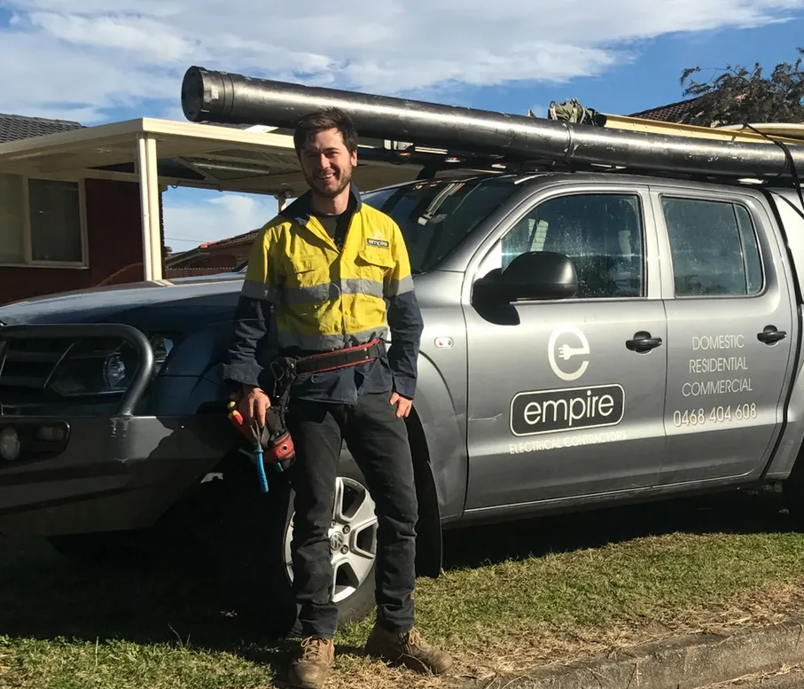 Empire electrician standing next to a fully stocked service van in Sydney