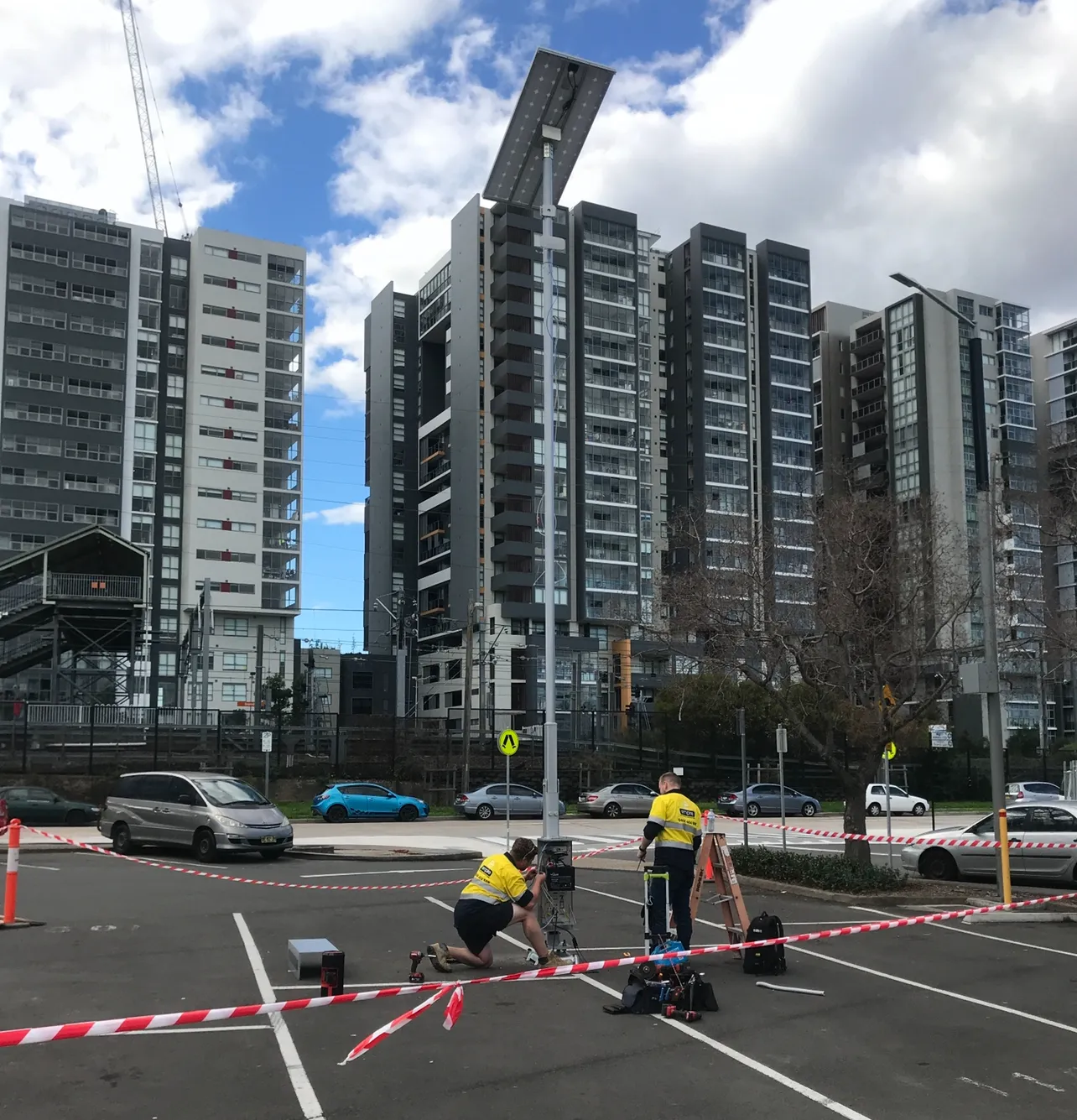 Empire electricians servicing a solar street light near Sydney apartments